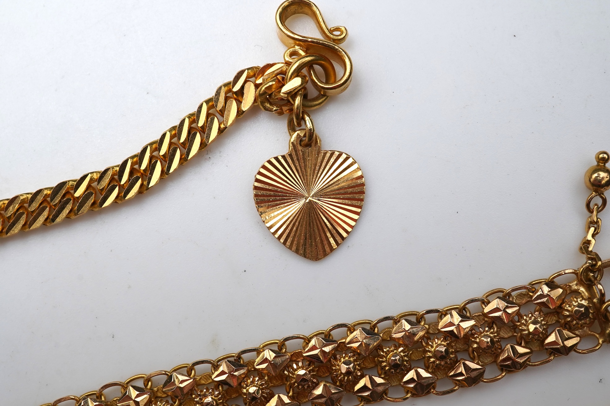 A Chinese pendant necklace and two gold bracelets